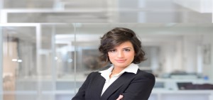 Business woman in an office. Crossed arms